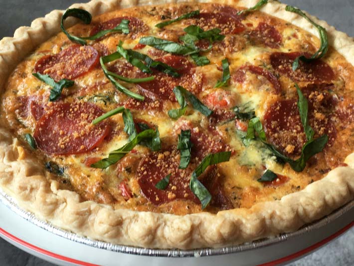 NYC Pepperoni Pizza Quiche Recipe that is make ahead easy. Grab some eggs, cream, and Italian seasonings and you have the perfect brunch recipe. www.ChopHappy.com 