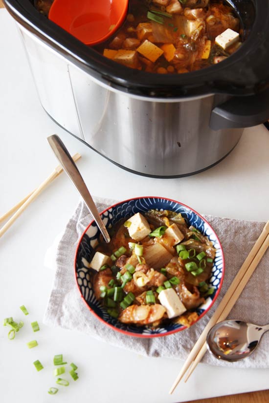 Slow Cooker Kimchi Soup Recipe- is a warm bowl of sweet and spicy comfort food hug. Just drop ingredients in slow cooker and come home to warm dinner. www.ChopHappy.com