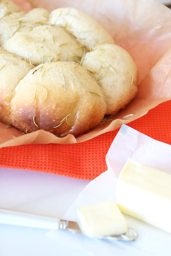 Slow Cooker Dinner Rolls Recipe - is so easy and makes more room in the oven. Grab dinner roll dough, garlic, rosemary, and a slow cooker (crock pot). This is magically awesome comfort food. www.ChopHappy.com #dinnerrolls