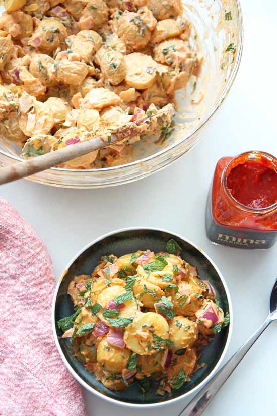 Creamy Harissa Potato Salad Recipe. This spicy, sweet and tangy #potatosalad is super easy to make and is perfect make ahead recipe. Happy #comfortfood cooking! www.ChopHappy.com