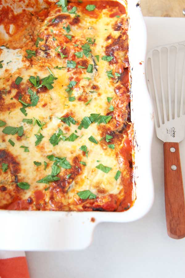 Best Baked Eggplant Parmesan Lasagna Recipe. We save time by roasting the eggplant for 10 minutes instead of breading and frying. This is a perfect weeknight dinner idea with lots of chess leftovers. Happy Cooking! www.ChopHappy.com #eggplantparmesan #dinneridea