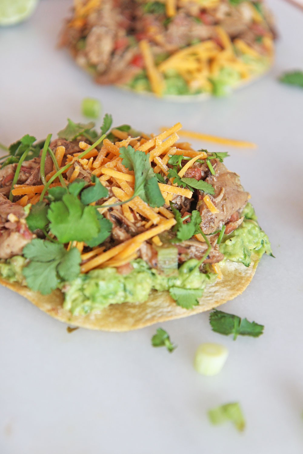 15 Minute Salsa Chicken Tostada Recipe. Grab your corn tortilla, rotisserie chicken, salsa, avocado, and cheese. This is baked in the oven and fast weeknight smiles. Happy Cooking! www.ChopHappy.com #chickenrecipe #tostada