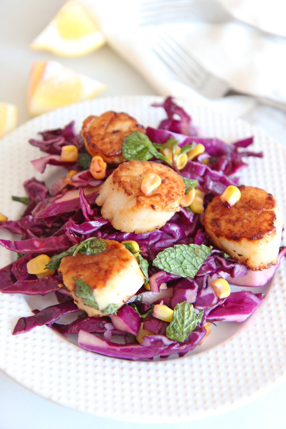 Scallops and Quick Cabbage Slaw Recipe. Grab scallops, red cabbage, shallots, apple cider vinegar, salt, pepper, mint, and enjoy! Easy summer recipe for busy weeknights! #scalloprecipe #slawrecipe