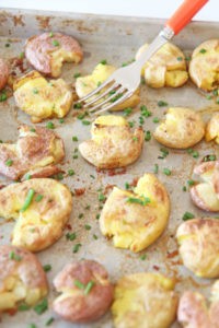 How To Make The Best Crispy Potatoes In The Oven. This is super easy side dish that is a perfect weeknight dinner idea. Grab chicken broth, Yukon gold potatoes, and garlic powder. Happy Sheet Pan Cooking! www.ChopHappy.com #crispypotatoes #howtocookpotatoes