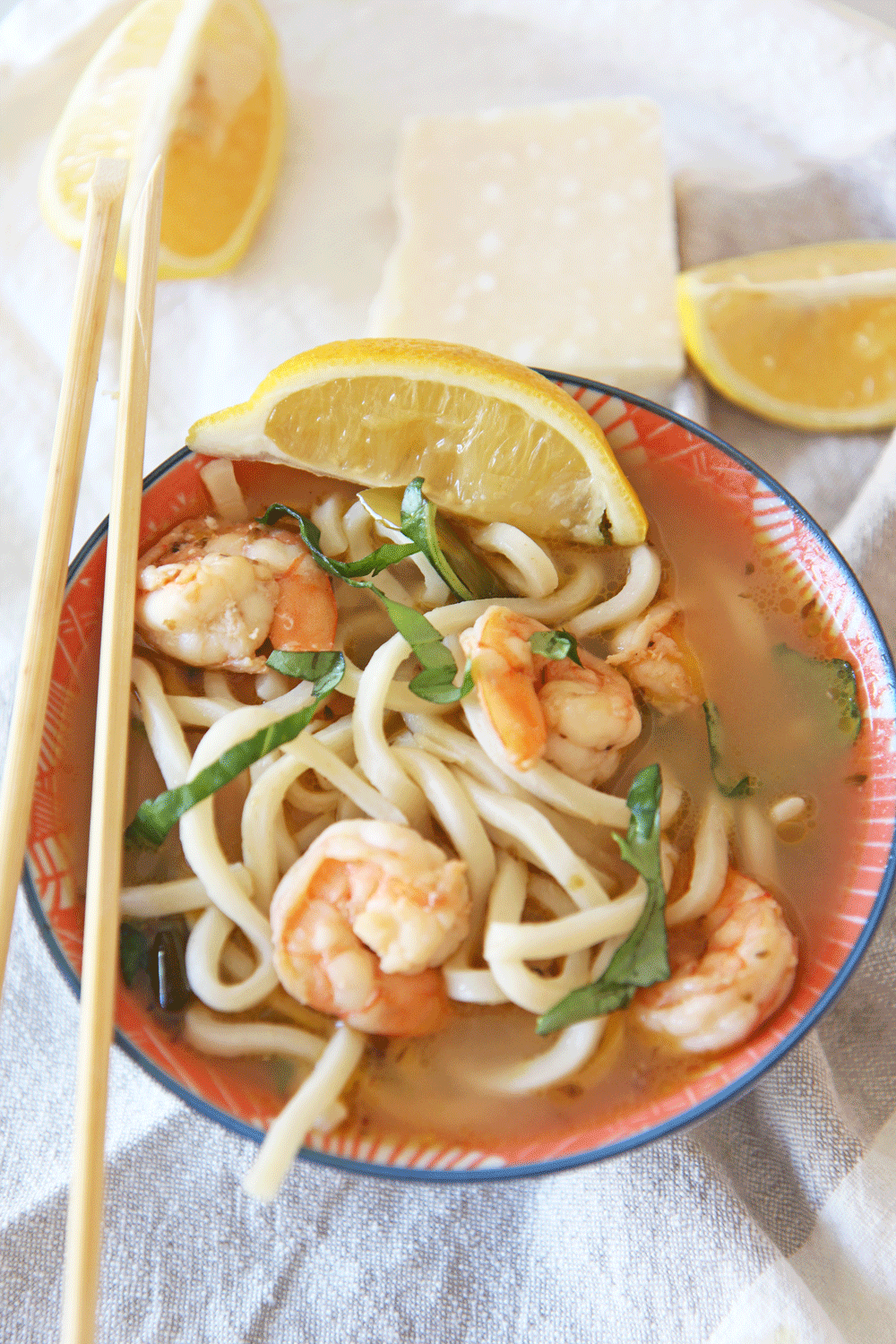 Shrimp Scampi Udon Noodle Soup Recipe. Simple 30 minute recipe that is one pot and comfort food yum. This is garlic, lemon, and chicken broth love mixed with udon noodles. Happy Cooking! www.ChopHappy.com #noodlesoup #shrimpscampi