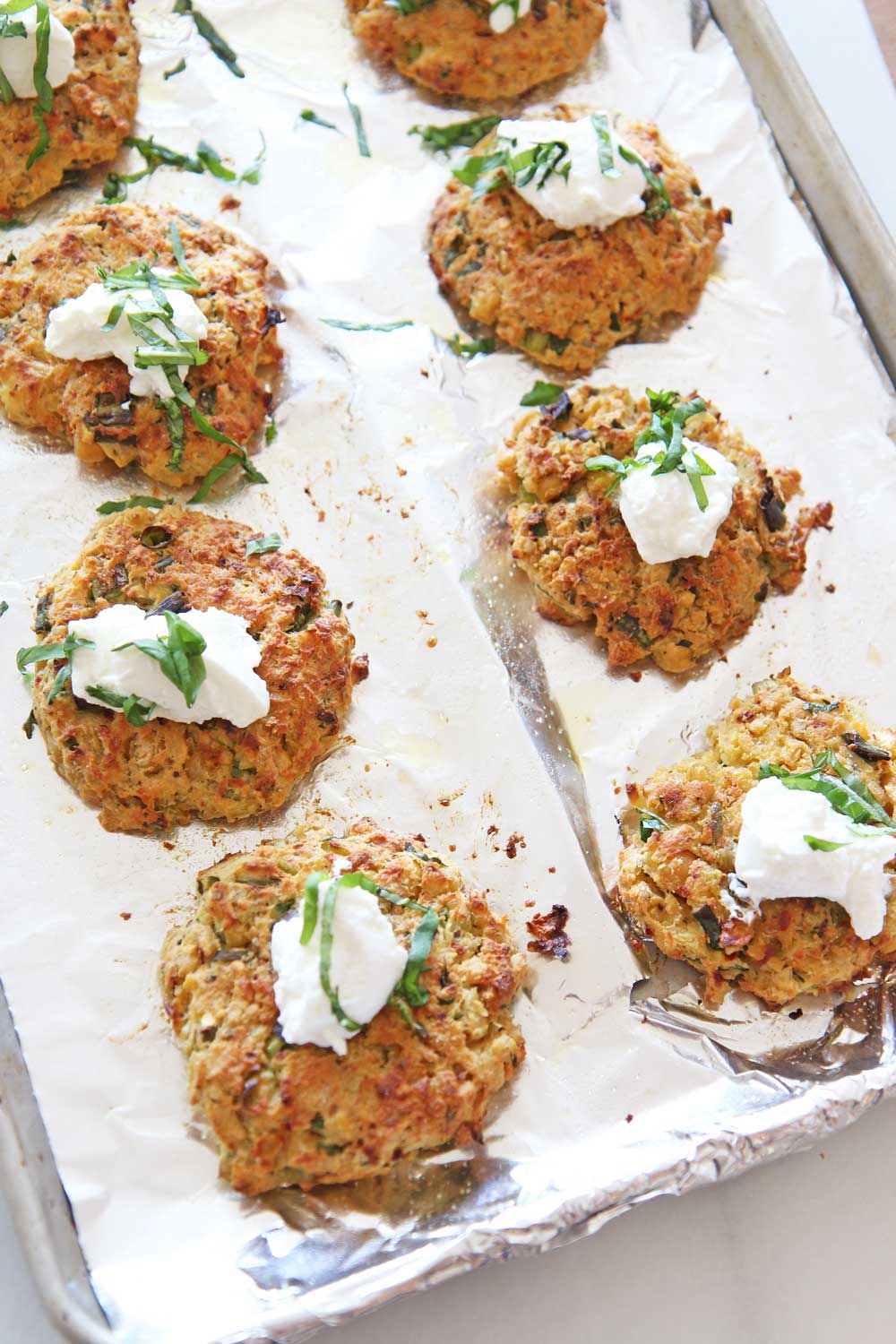 Cheesy Italian Chickpea Fritters (easy pantry recipe). Pantry ingredients make amazing dinners. By using the sheet pan this is a healthy recipe. No frying makes this healthier but also less mess. Grab chickpeas, ricotta, garlic powder, eggs, oregano, red pepper flakes, bread crumbs, and salt/ pepper. Happy Cooking! www.ChopHappy.com #chickpeas #pantryrecipe