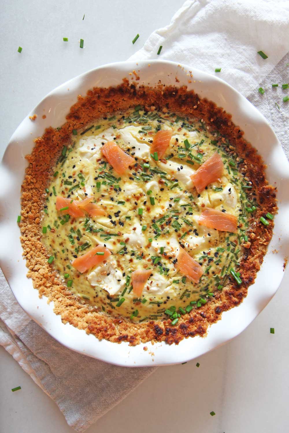 Bagel and Lox Quiche with Matzo Pie Crust Recipe. Perfect Passover recipe that is kosher for Passover. This tasted like a bagel with lox and cream cheese on an hot everything bagel. Lox, cream cheese, everything bagel seasoning, chives, eggs, and milk make up this awesome recipe. You can eat this for brunch, breakfast, dinner, or a snack. Happy Passover! www.ChopHappy.com #Passoverrecipe #matzo