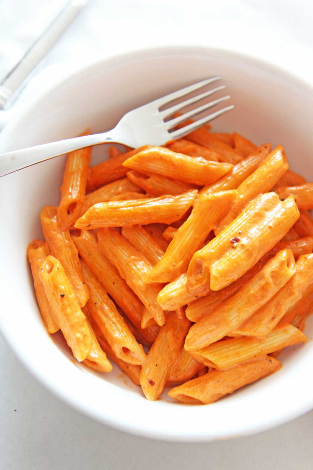 How To Make Penne Alla Vodka Pasta (Carbone copycat recipe). Grab cream, garlic, tomato paste, red pepper flakes, and pasta. This is a 20 minute one pot recipe that is a perfect weeknight dinner or pasta part. This is a copycat Carbone's Spicy Vodka sauce. Happy pasta making. www.ChopHappy.com #penneallavodka #vodkasauce
