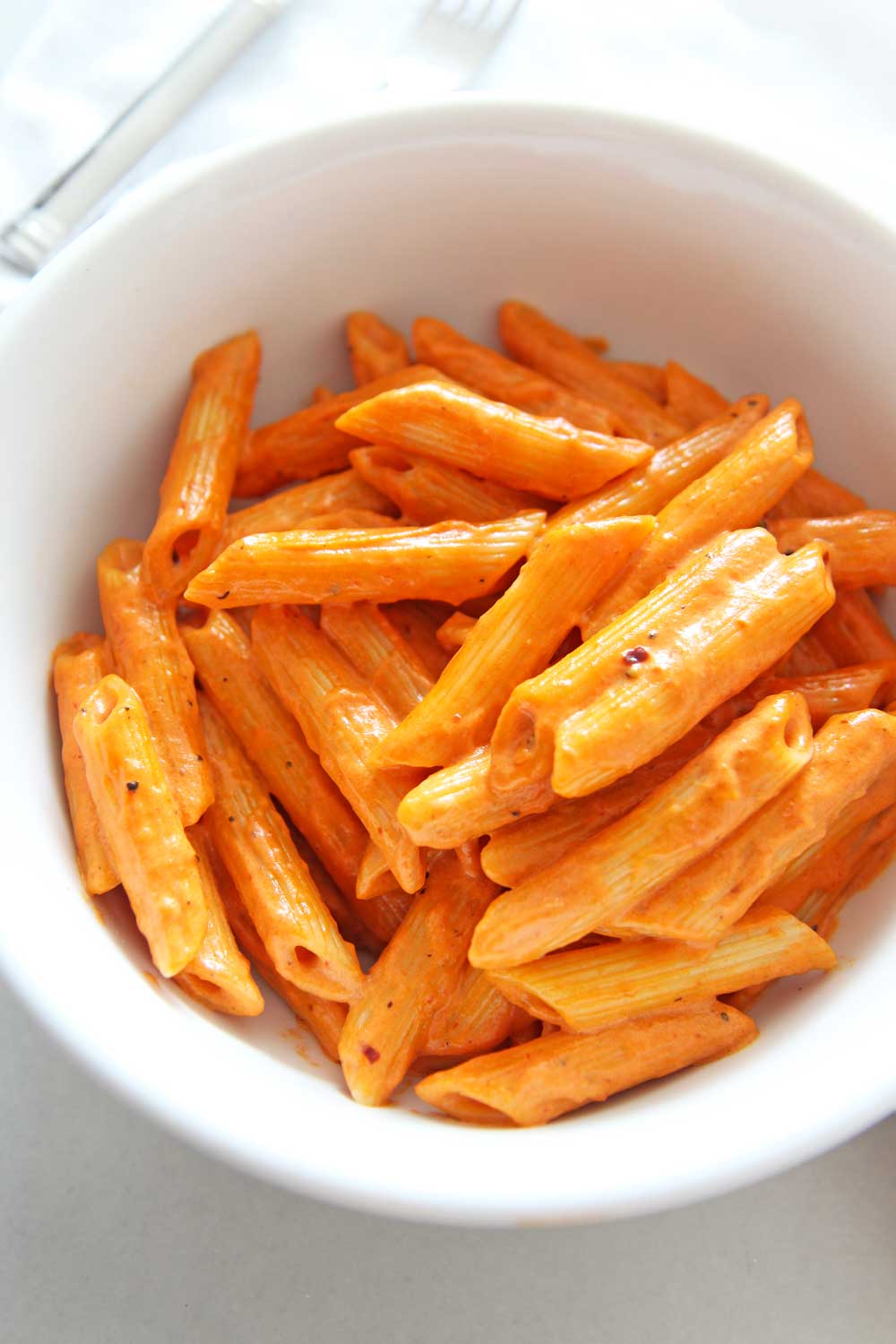 How To Make Penne Alla Vodka Pasta (Carbone copycat recipe). Grab cream, garlic, tomato paste, red pepper flakes, and pasta. This is a 20 minute one pot recipe that is a perfect weeknight dinner or pasta part. This is a copycat Carbone's Spicy Vodka sauce. Happy pasta making. www.ChopHappy.com #penneallavodka #vodkasauce