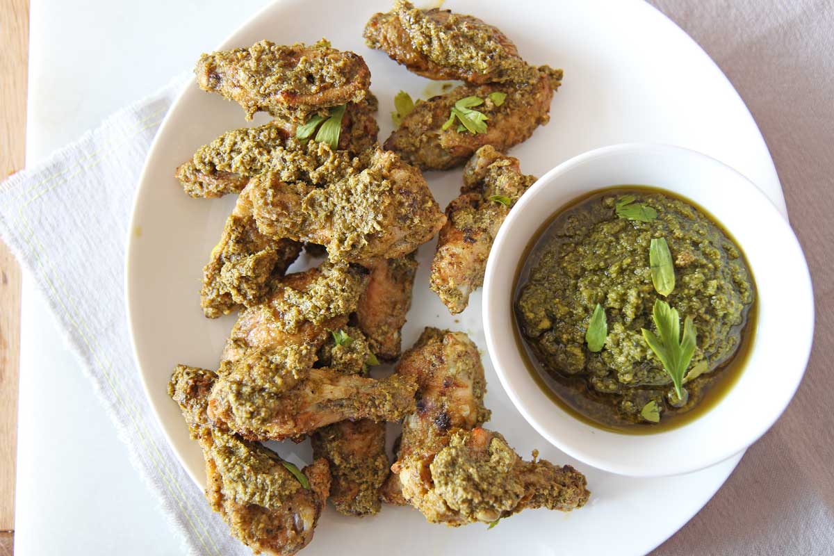 Oven Fried Pesto Chicken Wings. Easy 30 minute wing recipe with easy store bought pesto. www.ChopHappy.com #chickenwings #ovenfriedwings
