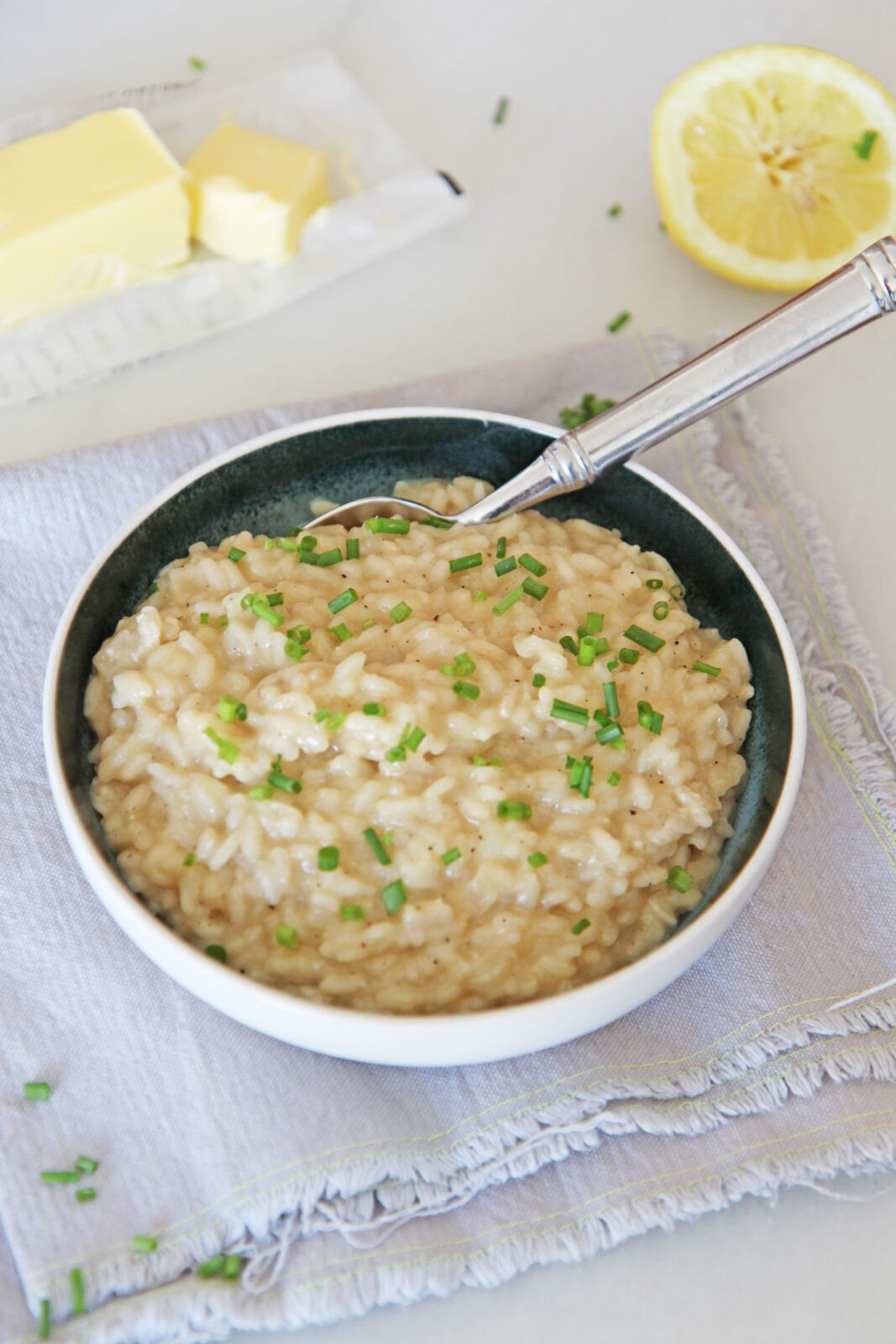 Risotto is a creamy pantry recipe that is comfort food in a bowl. This takes only 18 minutes and is just rice, broth, wine, shallots, butter and cheese.  www.ChopHappy.com #risotto #ricerecipe