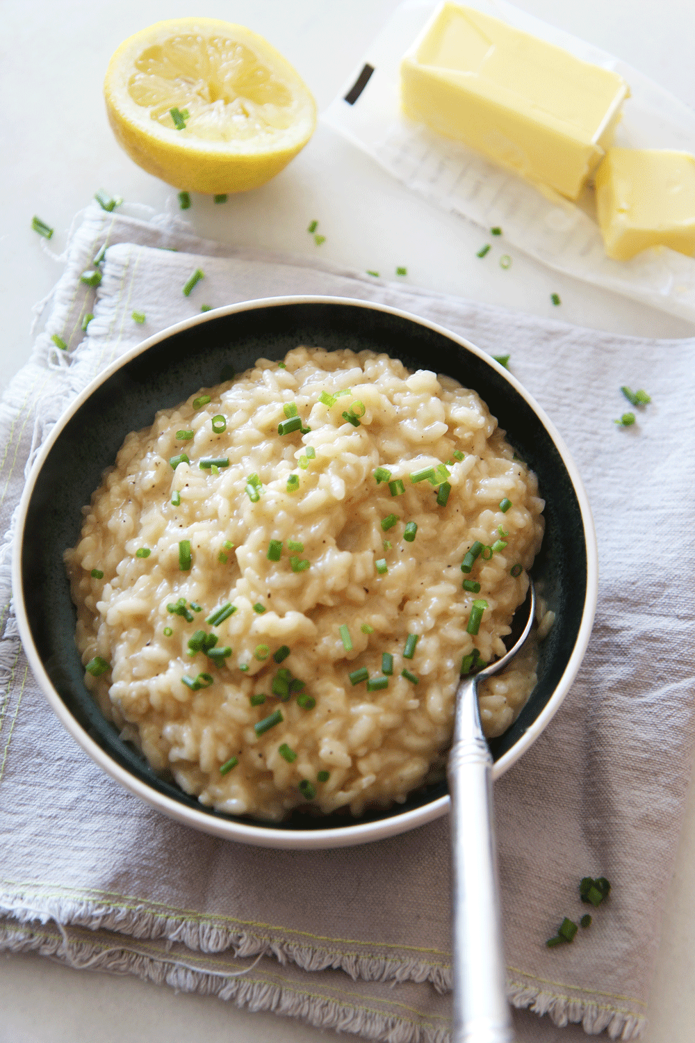 Risotto is a creamy pantry recipe that is comfort food in a bowl. This takes only 18 minutes and is just rice, broth, wine, shallots, butter and cheese.  www.ChopHappy.com #risotto #ricerecipe