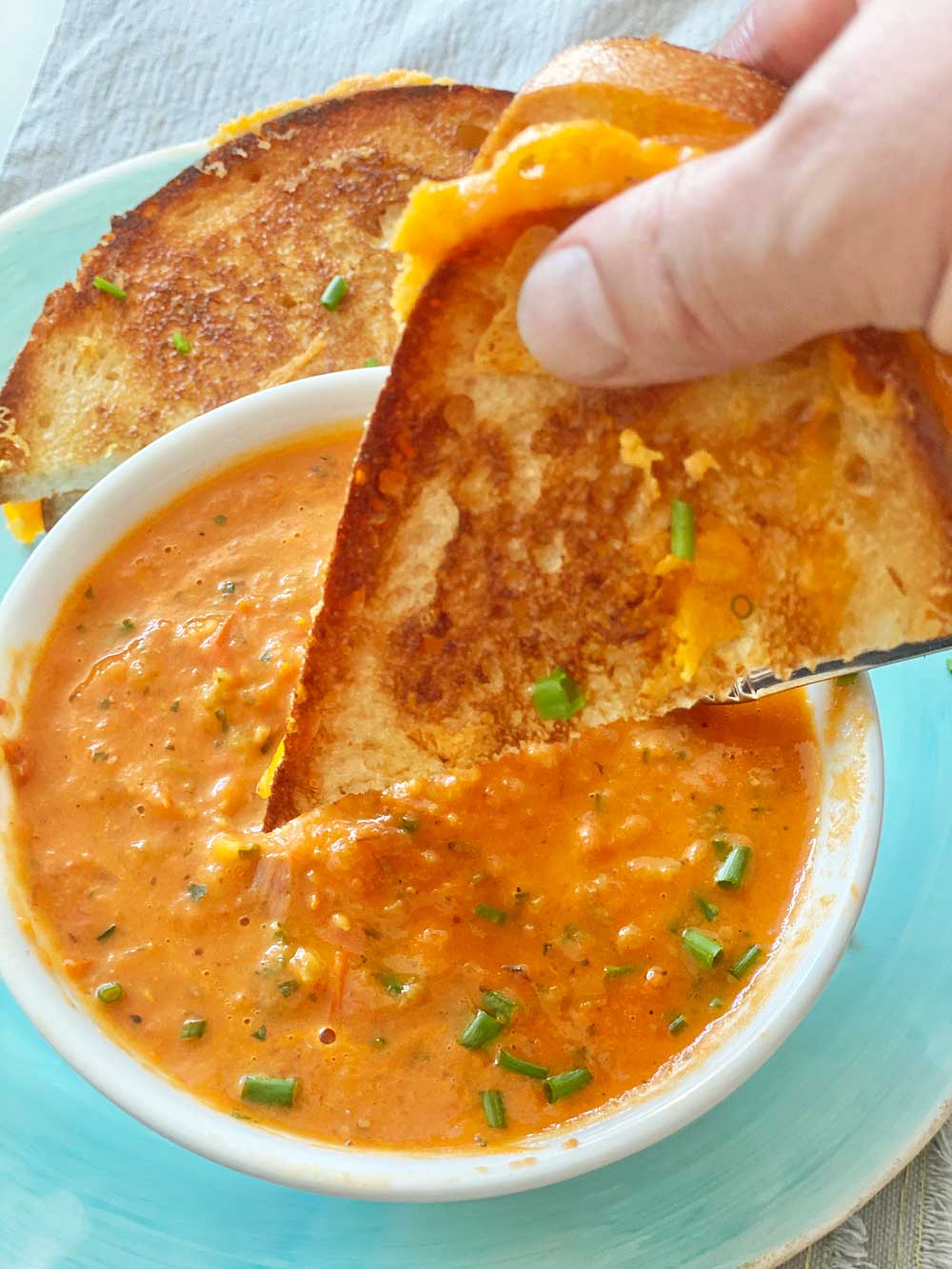 How To Make The Best Tomato Soup. Place tomatoes, shallots, roasted garlic, and seasoning on a sheet pan and roast in the oven. This is a simple soup recipe that has grilled cheese dunking fun. Happy Tomato Soup Cooking! www.ChopHappy.com #tomatosoup #roastedtomatosoup