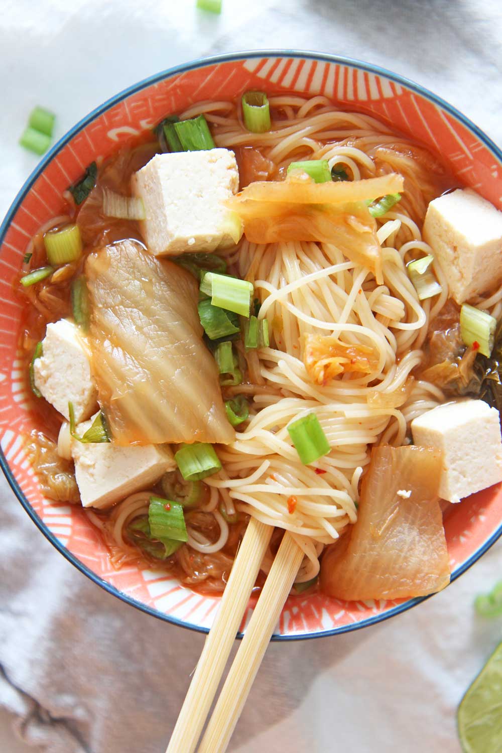 How to Make Kimchi Ramen Soup in a Slow Cooker. Grab noodles, tofu, kimchi, and scallions. Perfect soup that is all done in the crock pot. Happy Cooking! www.ChopHappy.com #souprecipe #ramenrecipe