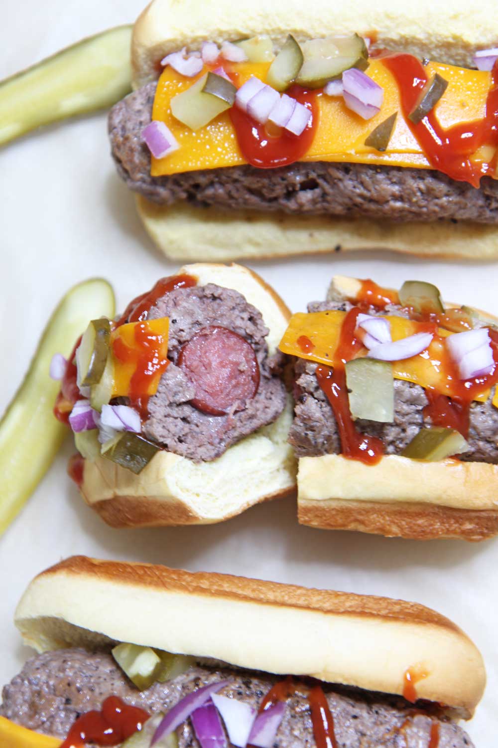 The Ultimate Burger Dog Food Hack. No more deciding weather to grill a hot dog or hamburger. This is a stuffed burger with a hot dog in the middle. Happy Grilling! #hotdog #foodhack