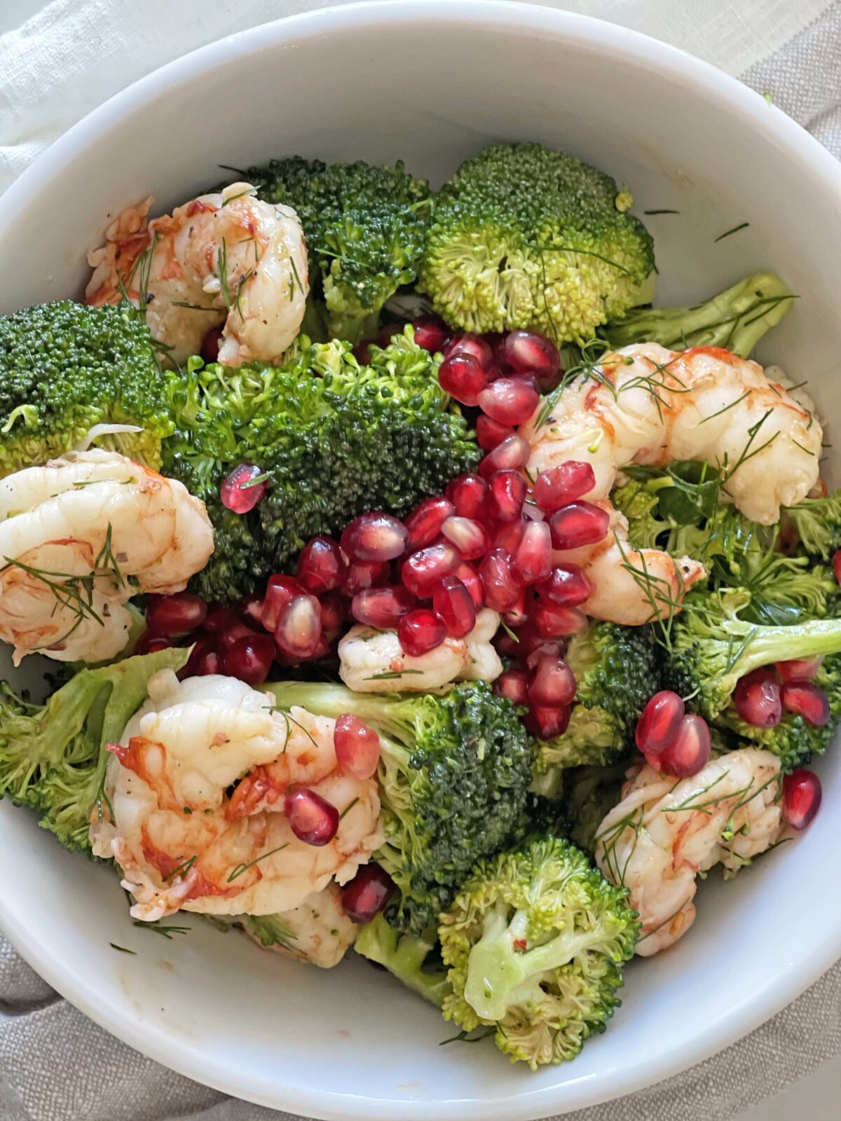 Easy Shrimp and Broccoli Salad. This is a perfect busy night dinner that has yummy leftovers. Broccoli, shrimp, pomegranates, Dijon mustard, and herbs. This is an easy Summer salad for a pool party. Happy Salad eating! www.ChopHappy.com #saladrecipe #broccolisalad