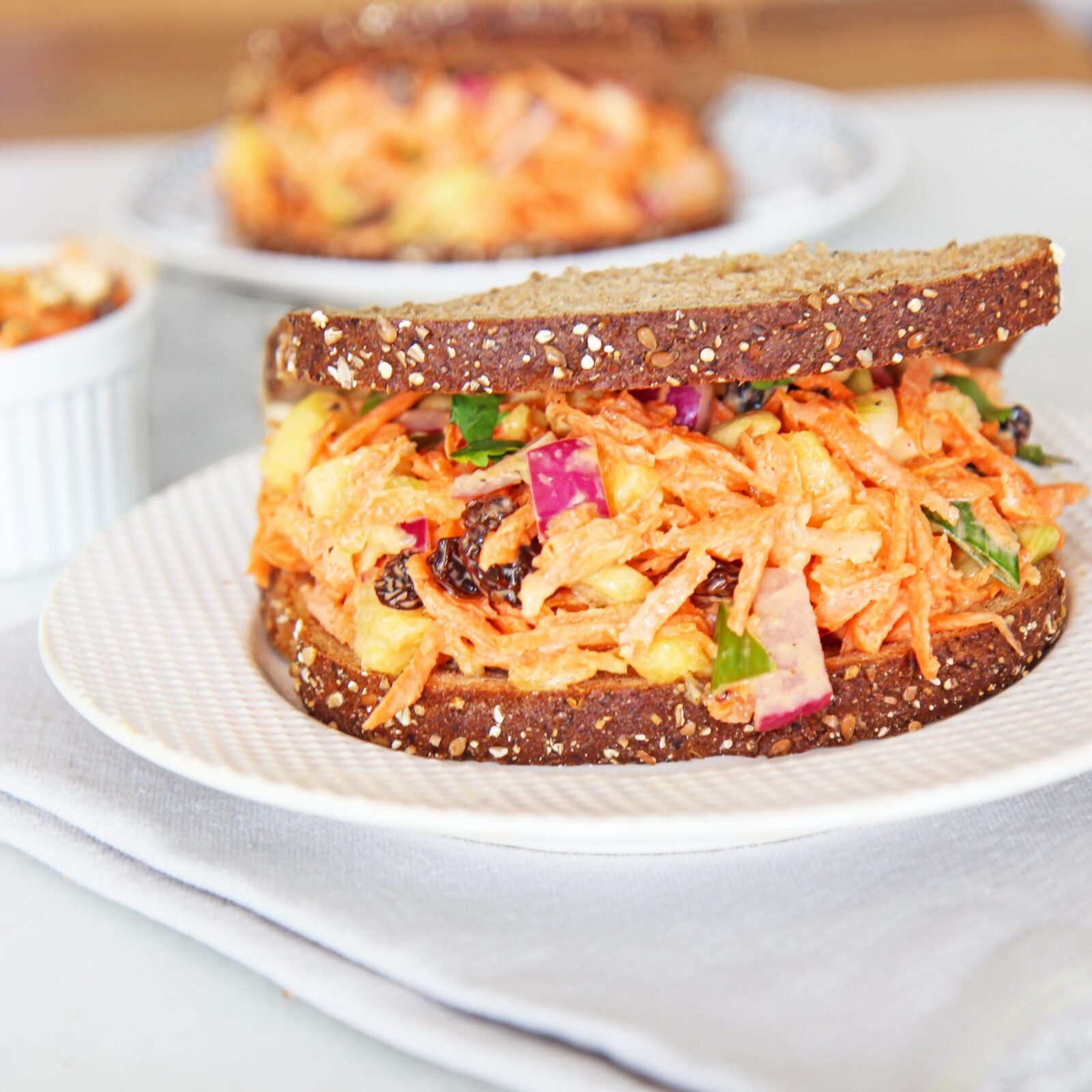 Carrot Salad Sandwich Recipe. This is a perfect vegetarian sandwich recipe that is healthy. This is from The Happy Sandwich Cookbook that has 50 recipes for busy people. www.ChopHappy.com #vegetariansandwich #sandwichrecipe