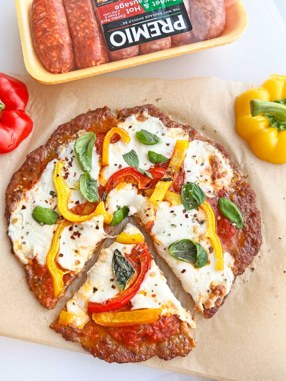 Sausage and Peppers Pizza (sausage crust). This is an easy gluten free pizza recipe or keto pizza recipe. The crust is made of sausage. Happy Cooking! www.ChopHappy.com #sausageandpeppers #pizza